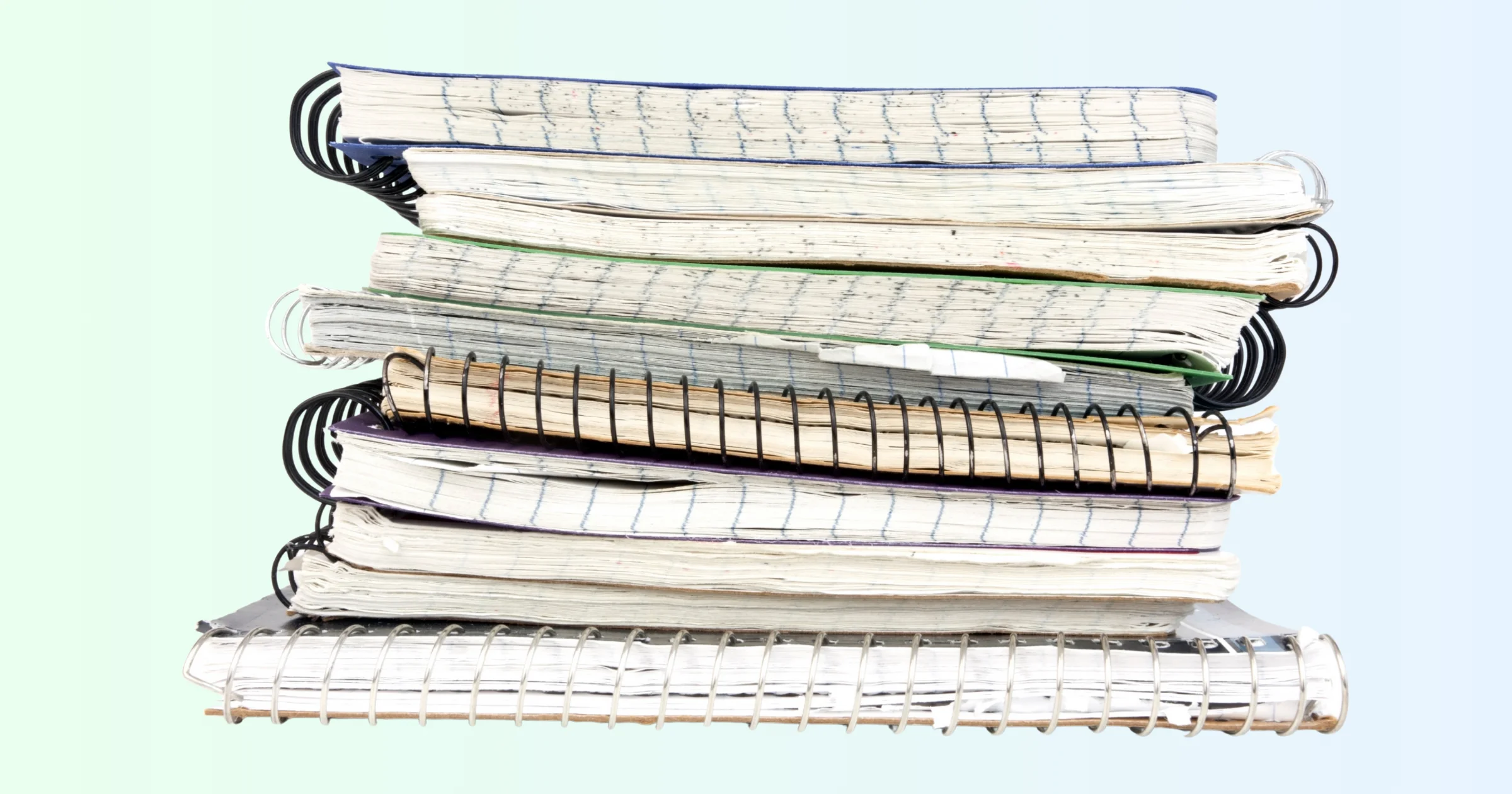 A stack of books, representing the weight of traditional journaling and abandoned notebooks